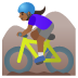 woman mountain biking, medium-dark skin tone